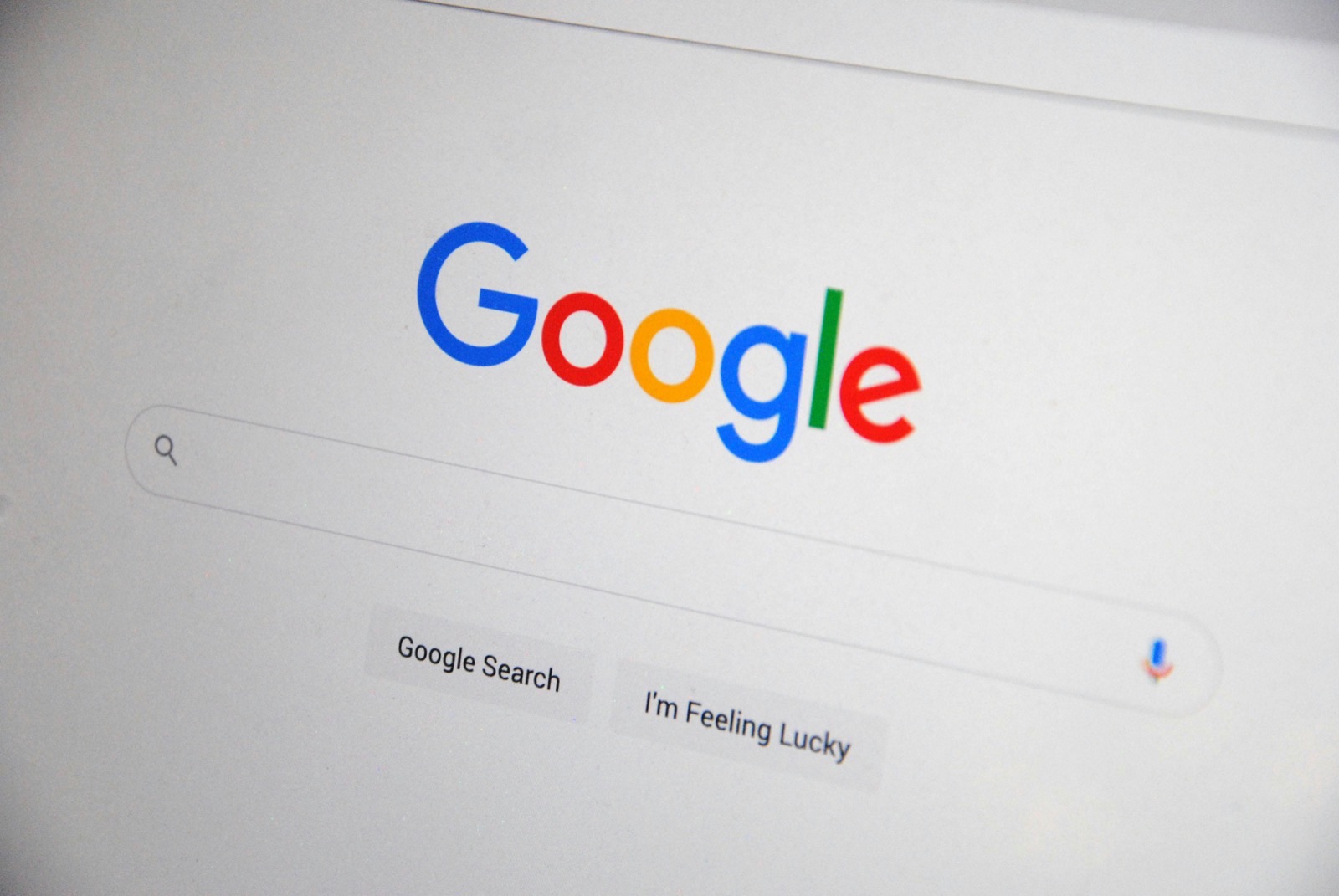 Google homepage with search bar and "Google Search" and "I'm Feeling Lucky" buttons displayed on a light background