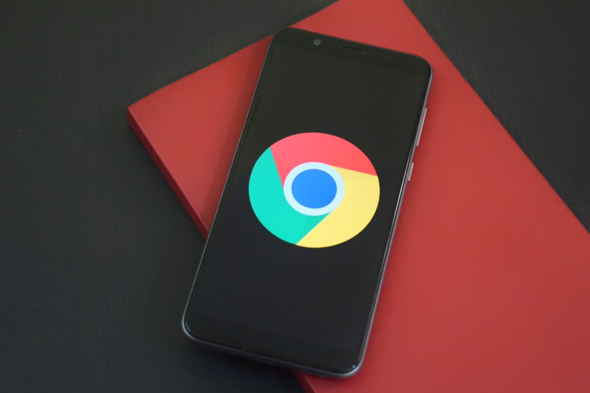 Smartphone displaying the Google Chrome logo on a red background