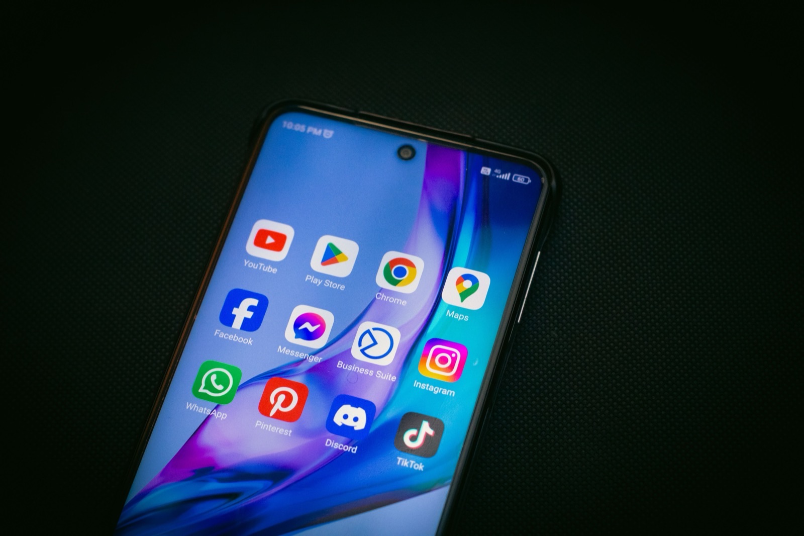 A smartphone home screen showing app icons including Chrome, Google Maps, Facebook, Instagram and TikTok