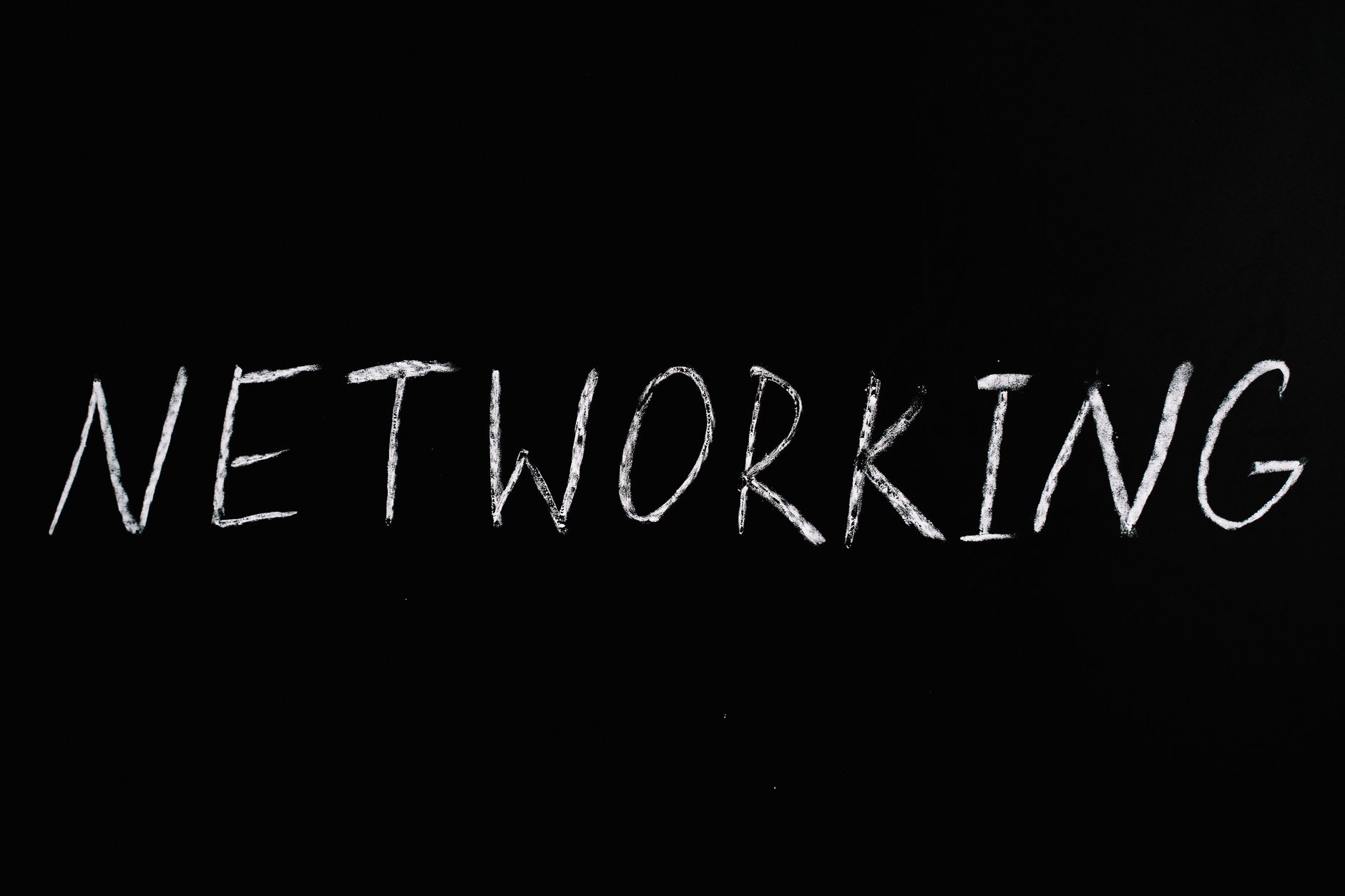 The word "NETWORKING" written in white chalk on a black background